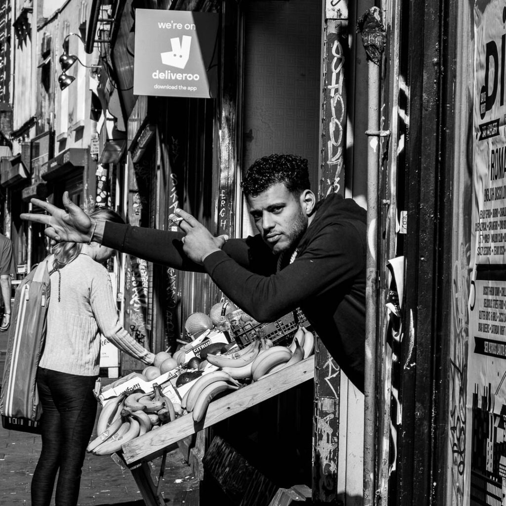 Urban street photography, shop keeper in Bristol