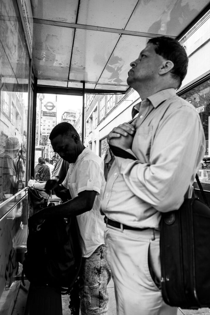 London street photography - Man at bus stop by Adrian Crook