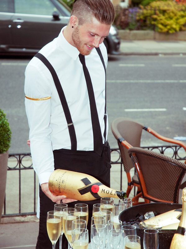 Adrian Crook Social Media image of Barman pouring champagne