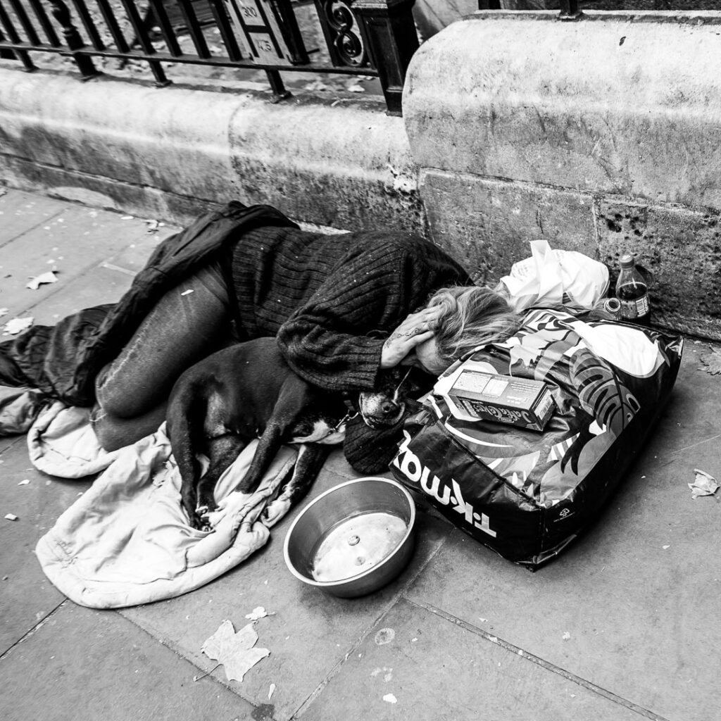London street photography - Homeless person with dog by Adrian Crook