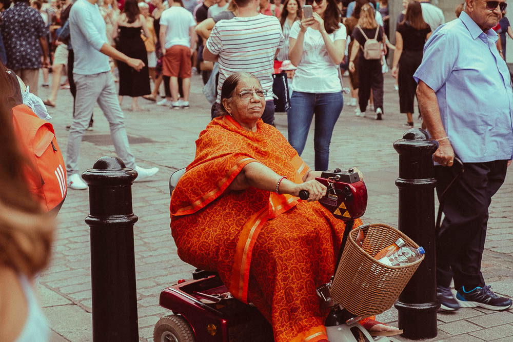 London street photography - Lady on a mobility scooter by Adrian Crook