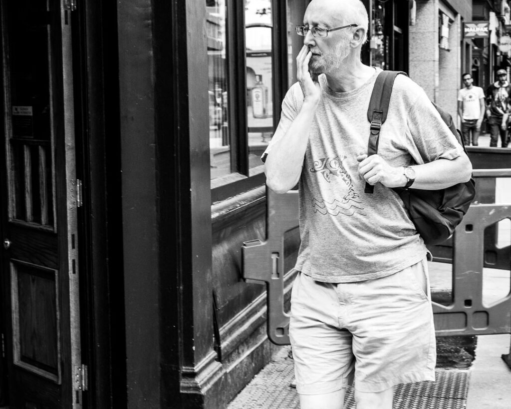 London street photography - pensive by Adrian Crook